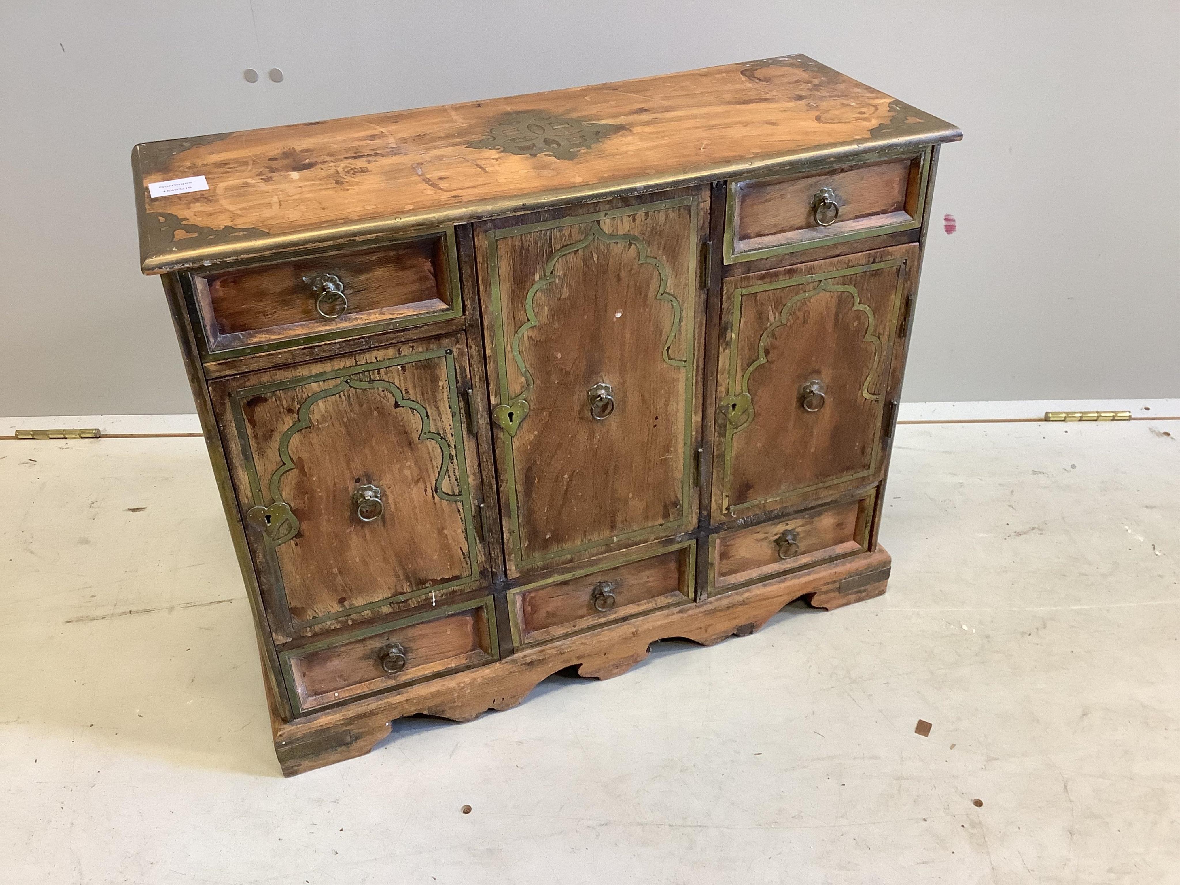 An unusual small Continental brass inlaid cabinet, fitted with three cupboards and five drawers, width 62cm, depth 25cm, height 50cm. Condition - fair